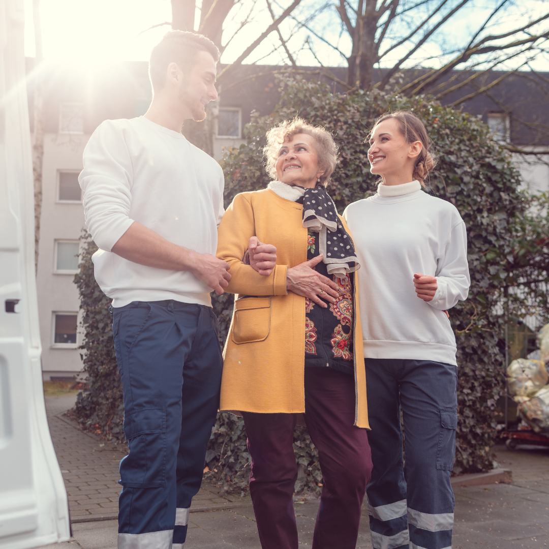 A man and two women are standing next to each other