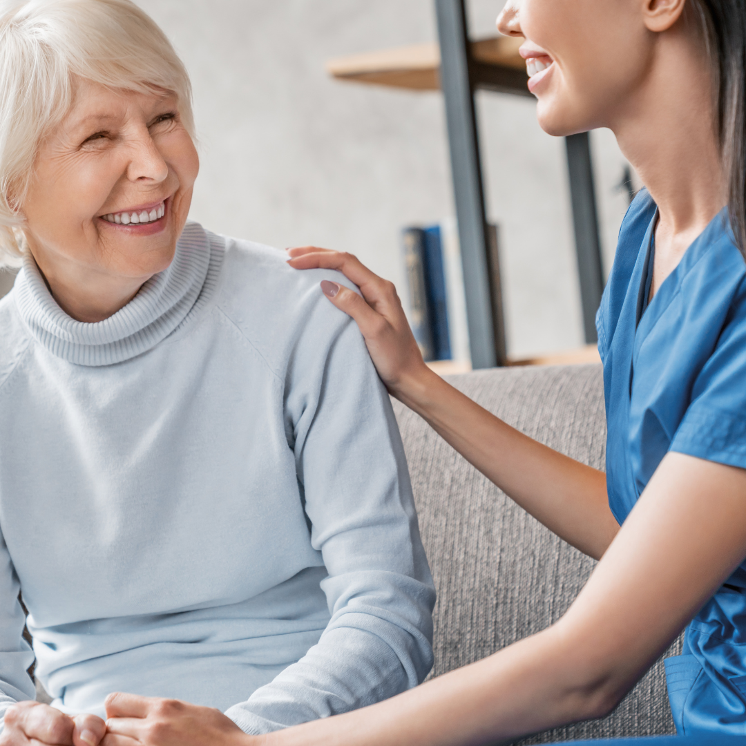 A nurse is putting her hand on an older woman 's shoulder.