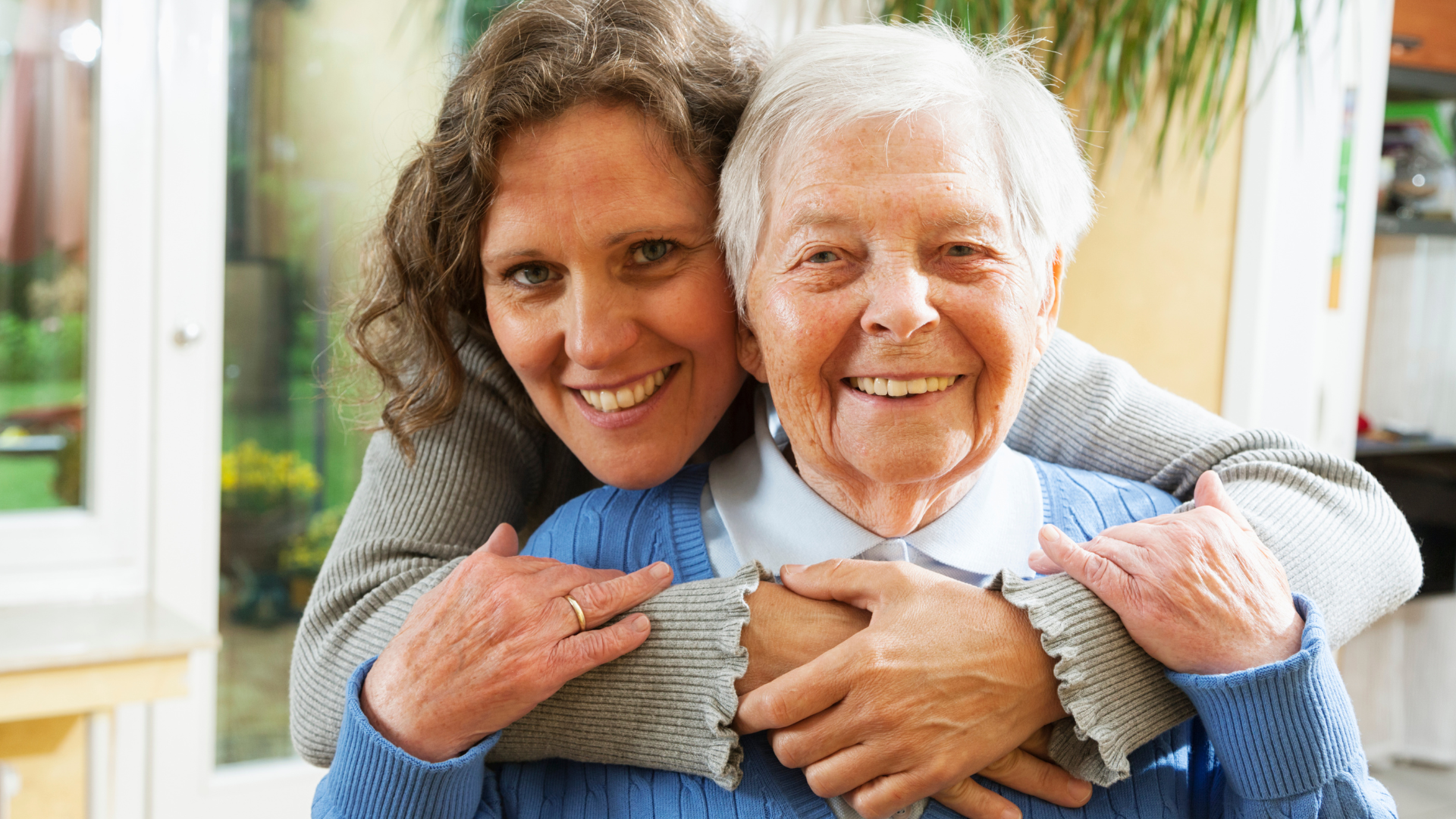 senior woman caregiver embrace