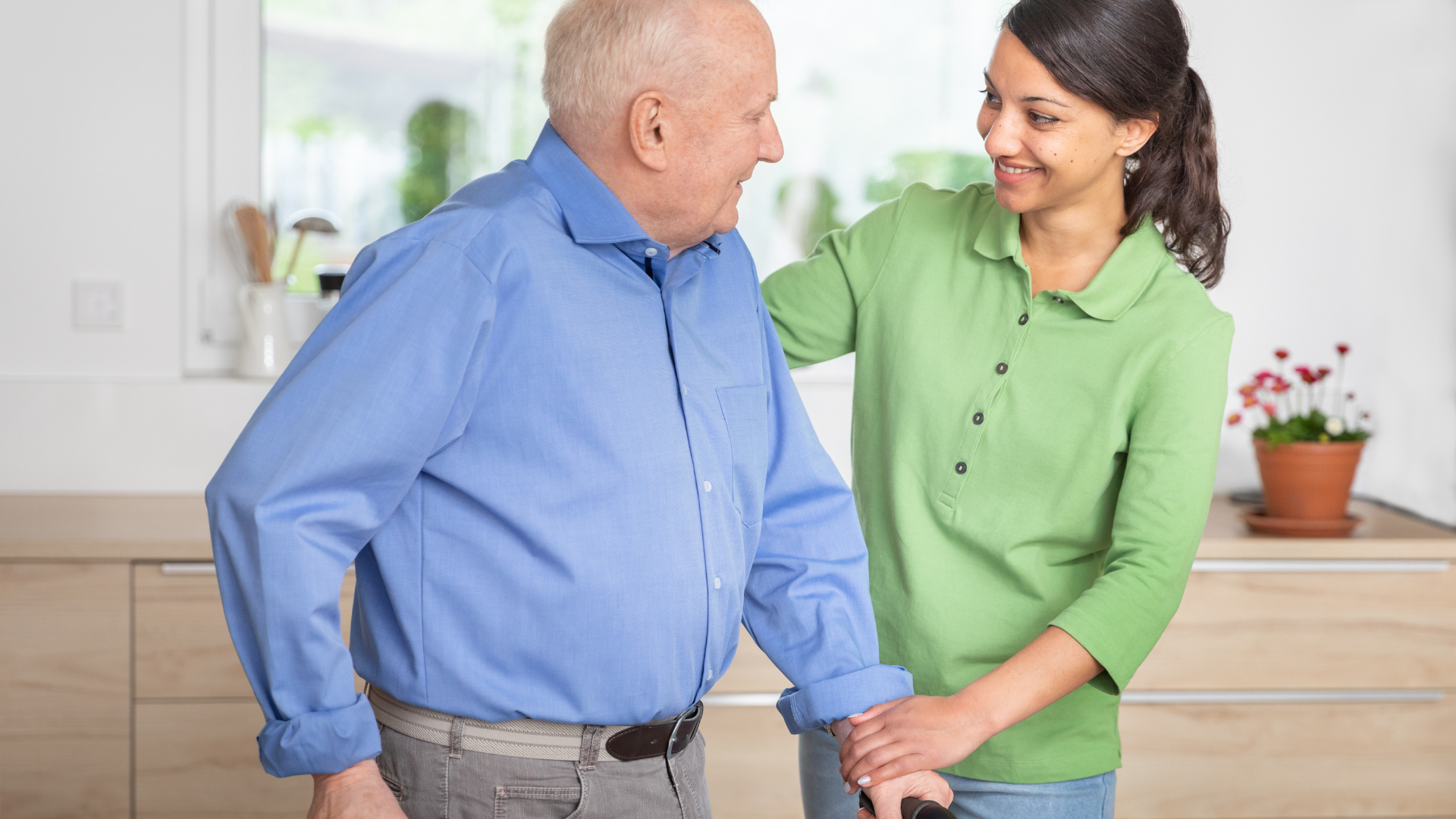 Home caregiver helping senior man