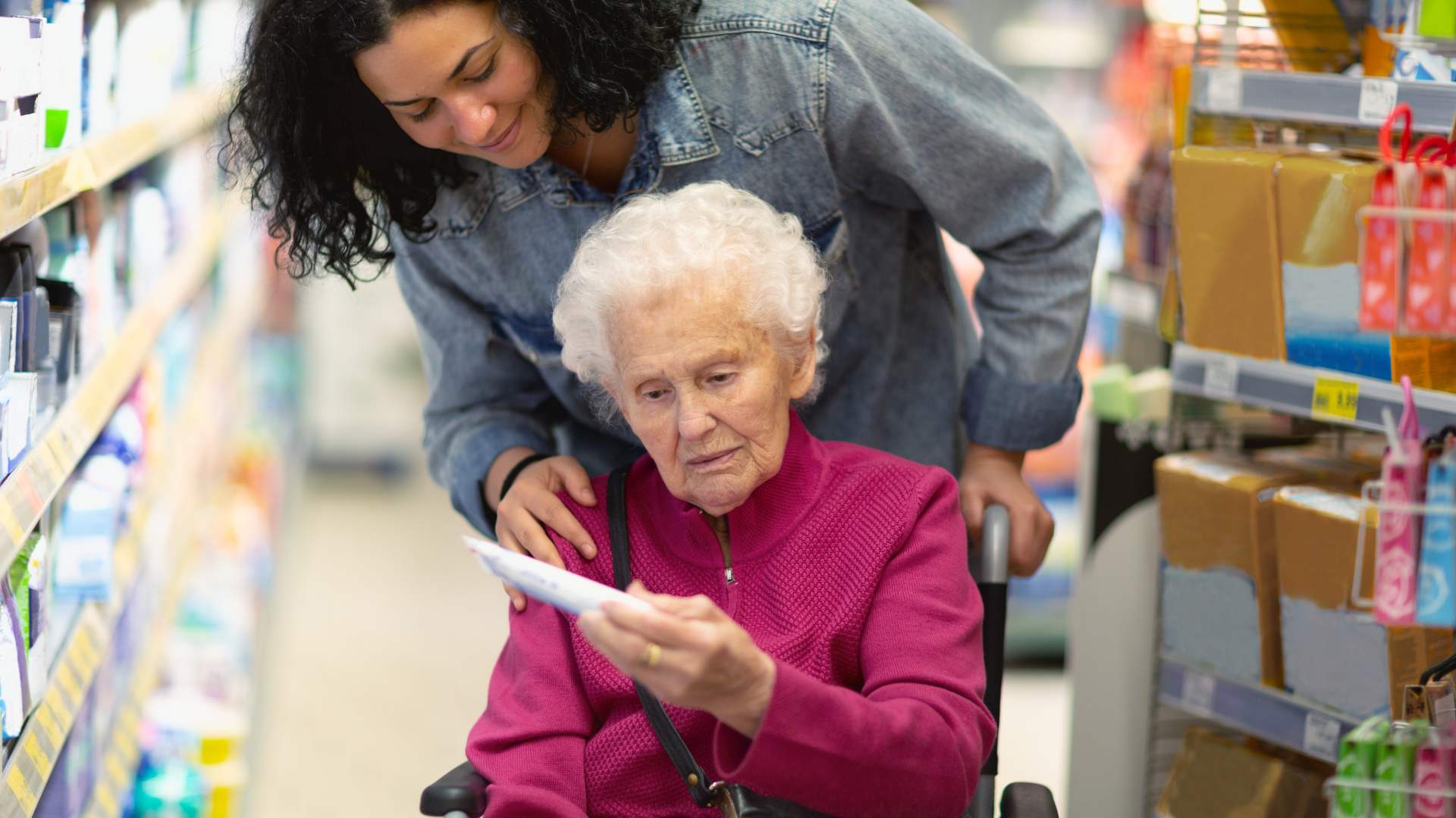 Caregiver helping senior woman with shopping