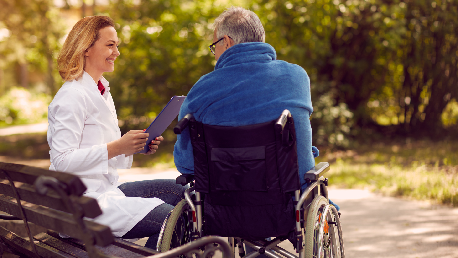 Hospice checking up the history of the patient in wheelchair