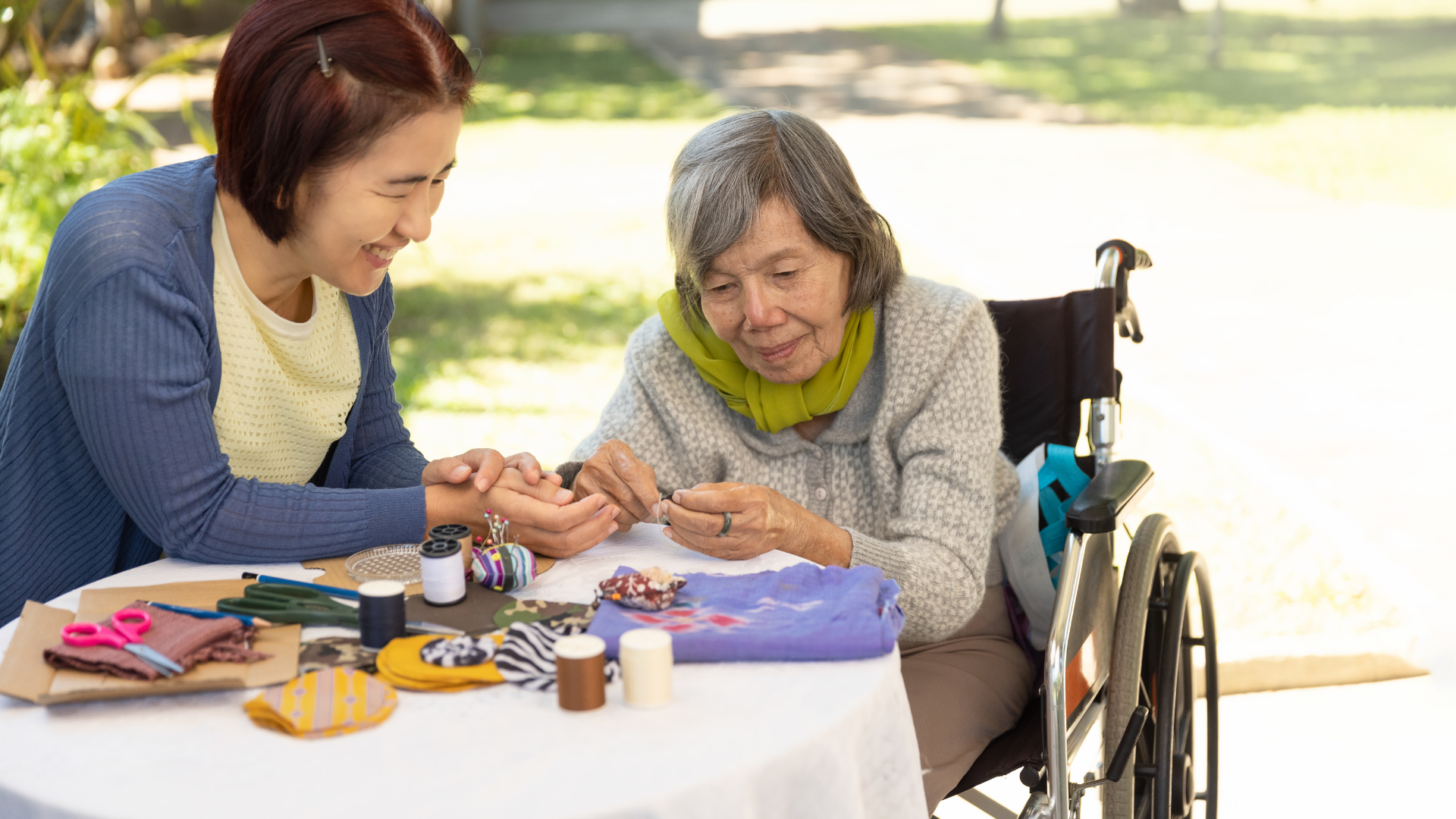 Elderly woman and daughter in the needle crafts occupational therapy for Alzheimer’s or dementia