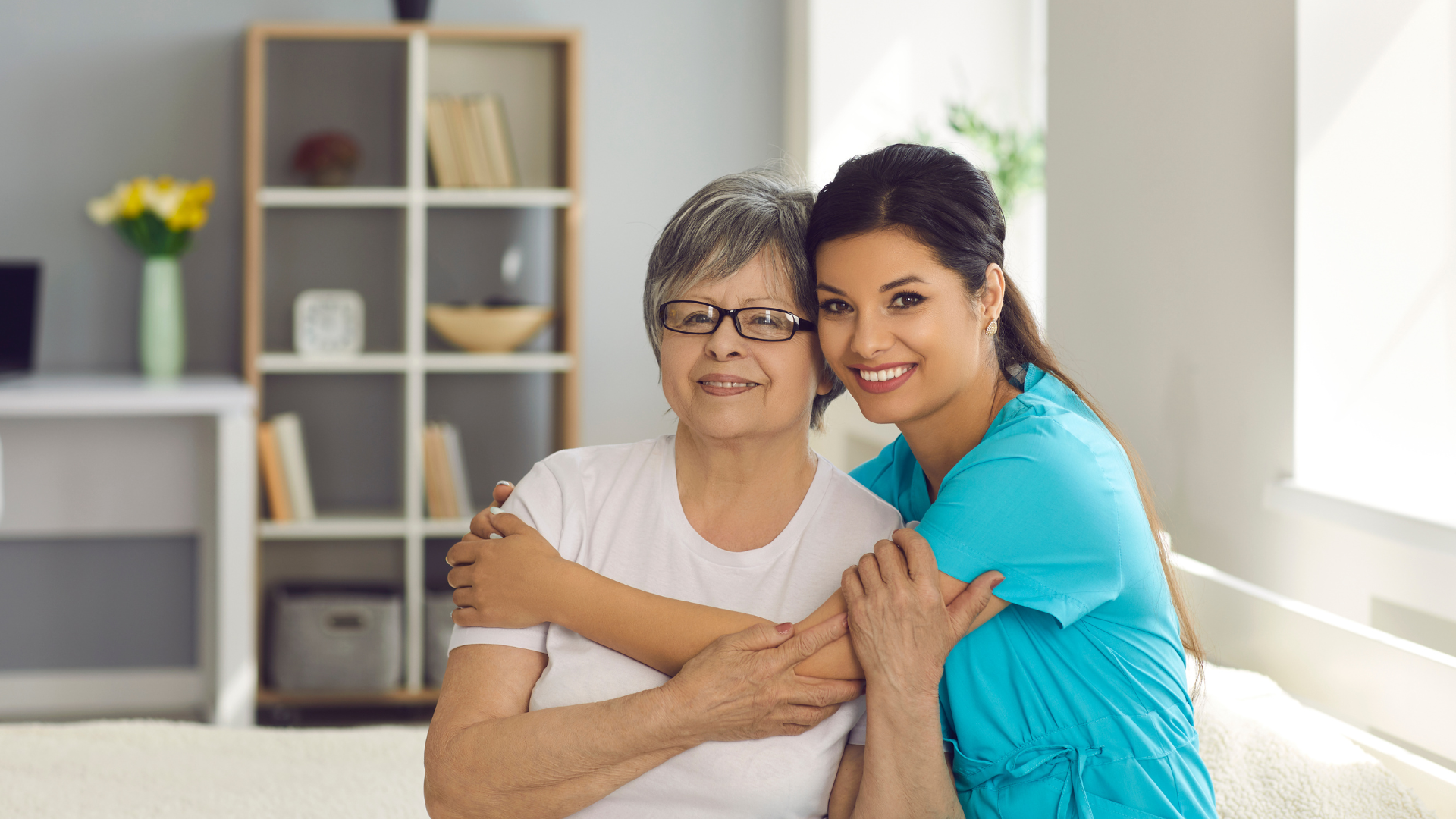 Happy Senior Woman Together with Her Home Care Nurse or Caregiver Smiling at Camera