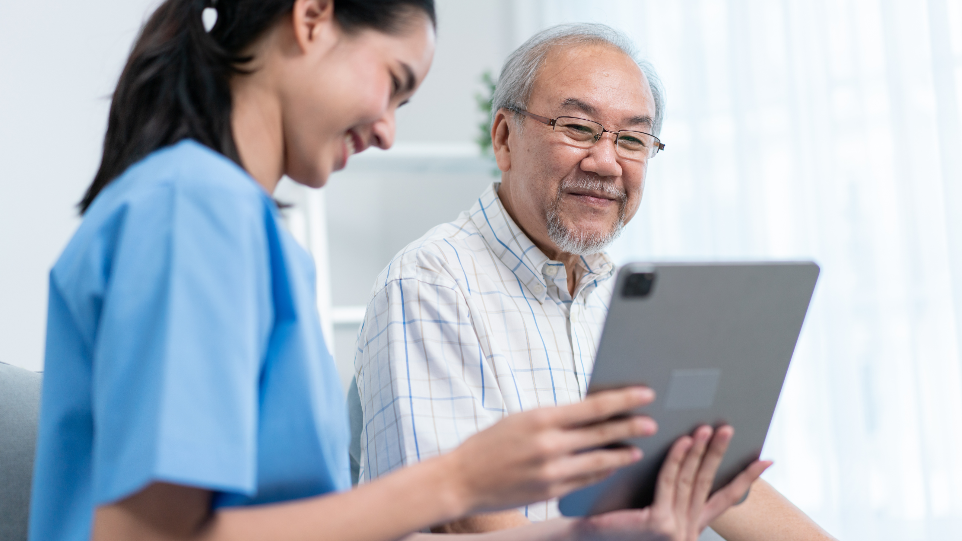 Asian nurse showing health checkup report to grandfather