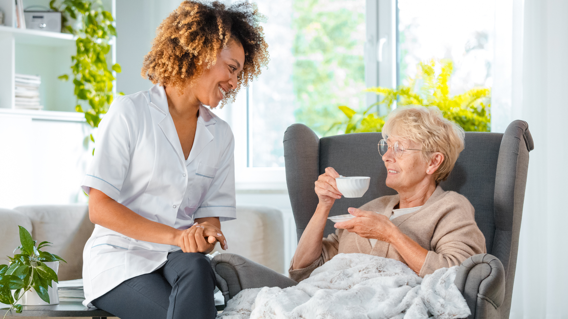 Cheerful nurse taking care of elderly lady