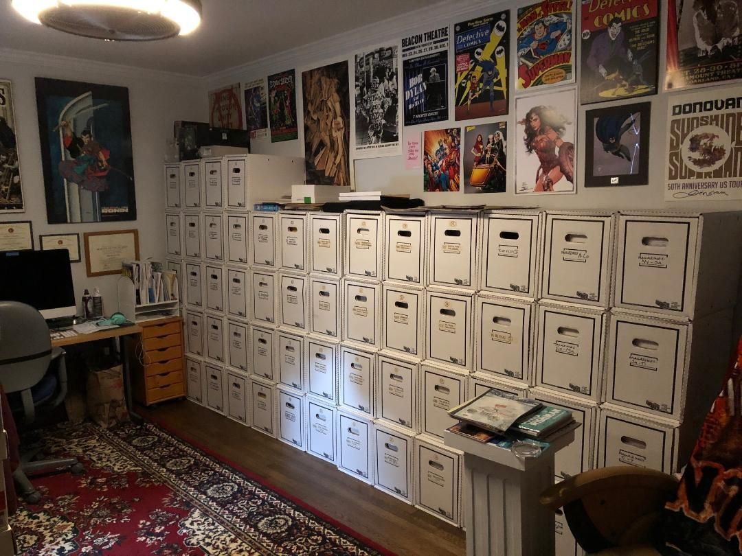 A room with a lot of boxes and posters on the wall