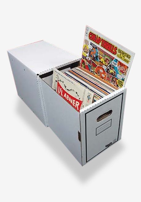 A cardboard box filled with comic books and a magazine.