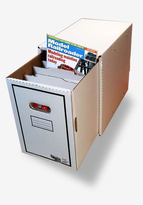 A cardboard box filled with model railroader magazines