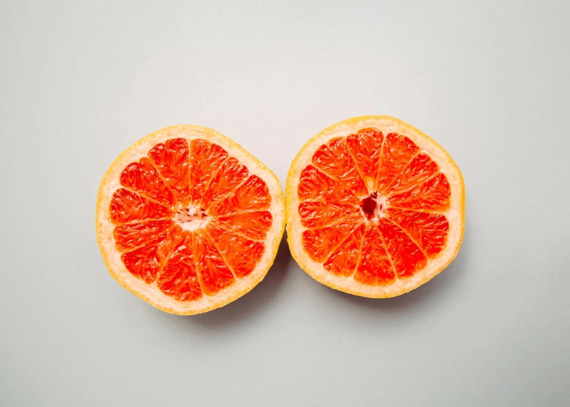 Two Grapefruit Slices Are Cut in Half on A White Surface — Action Physiotherapy in Cooks Hill, NSW