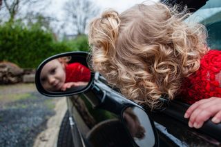 Windshield Replacement — Toddler Looking at Her Reflection in Car Mirror in Warminster, PA