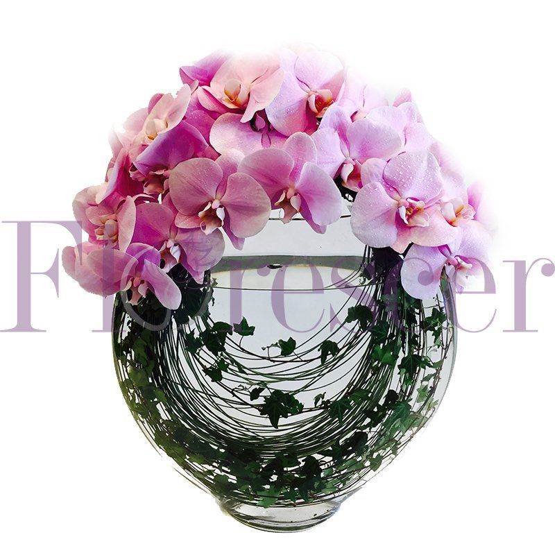 A vase filled with pink flowers with the word forever in the background