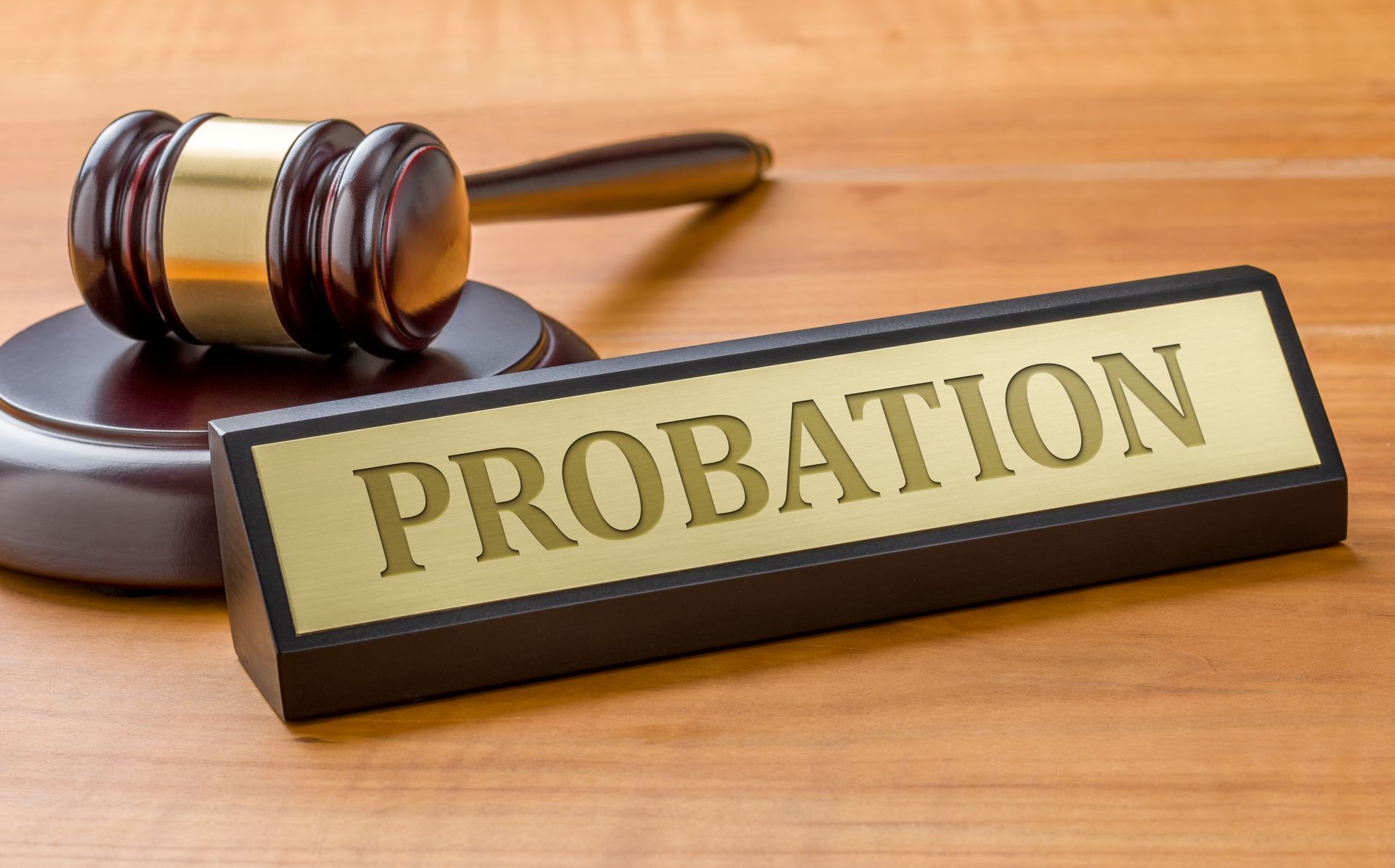 A wooden sign that says probation next to a judge 's gavel