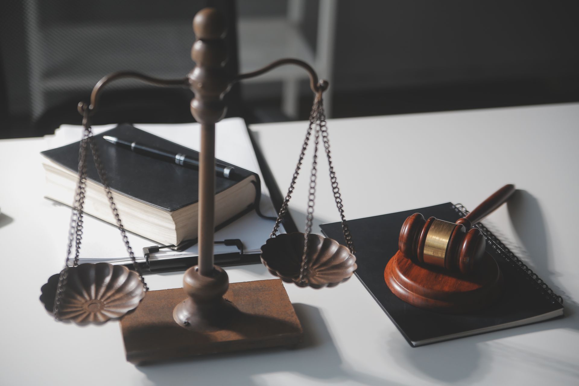 A scale of justice and a judge 's gavel are on a table.