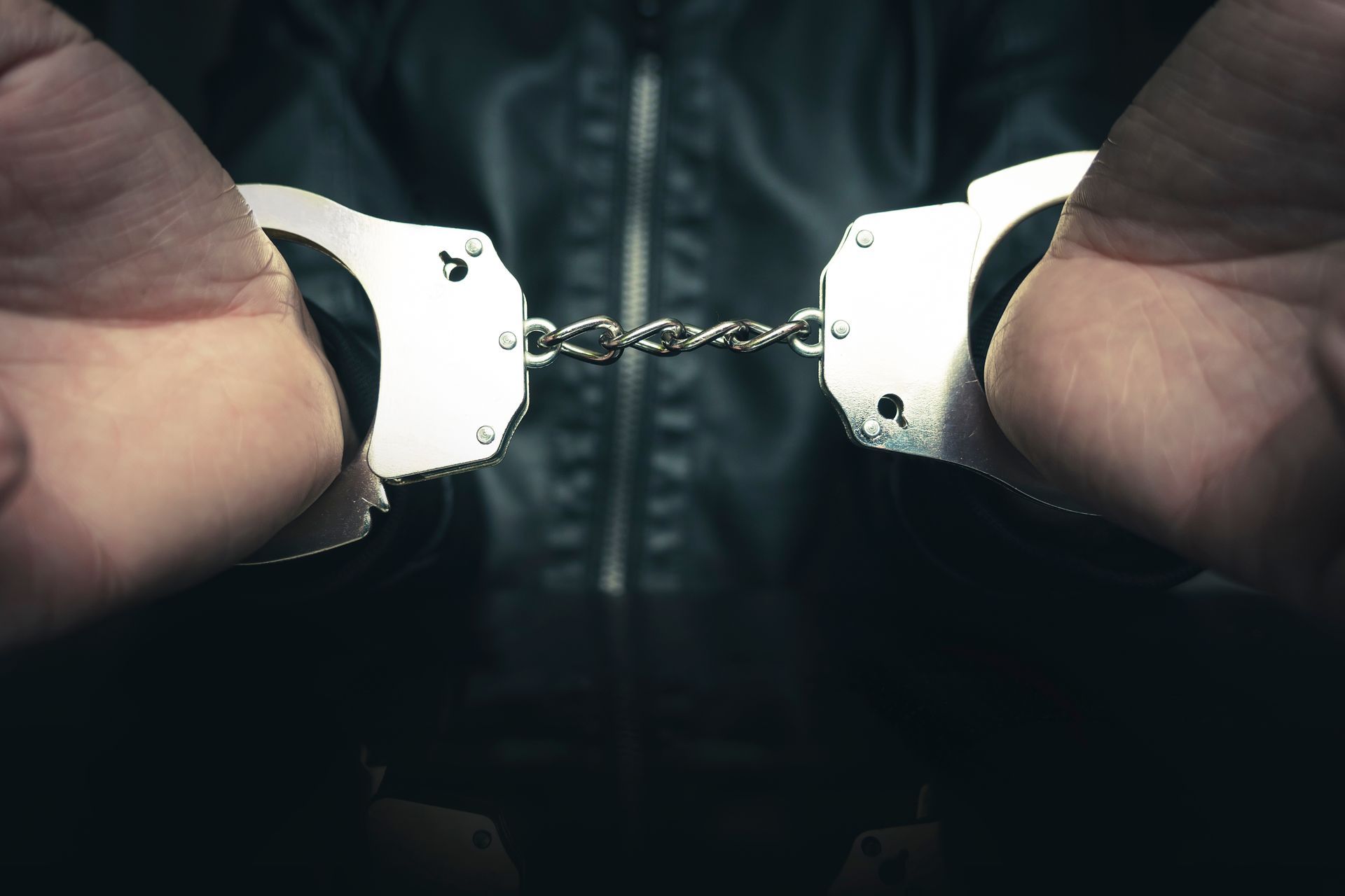 A close up of a person wearing handcuffs