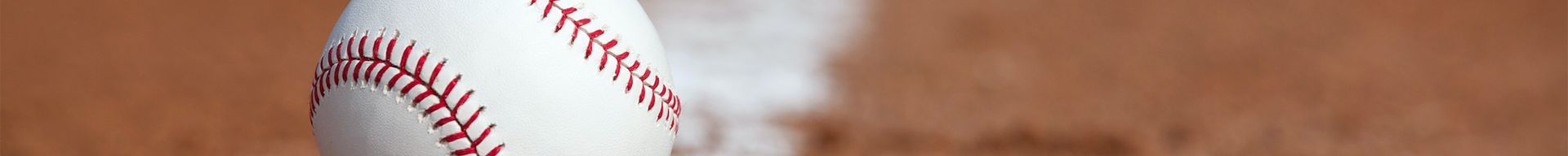 A close up of a candy cane on a wooden table.
