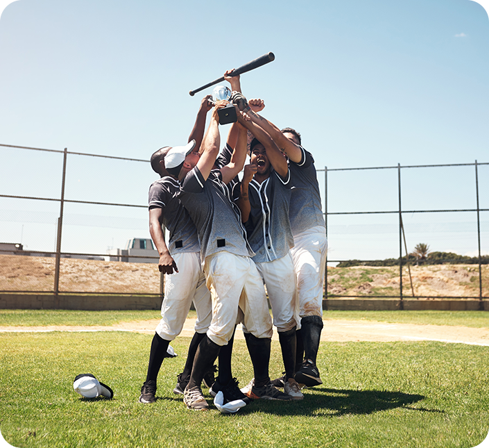 A group of baseball players are holding a bat over their heads.