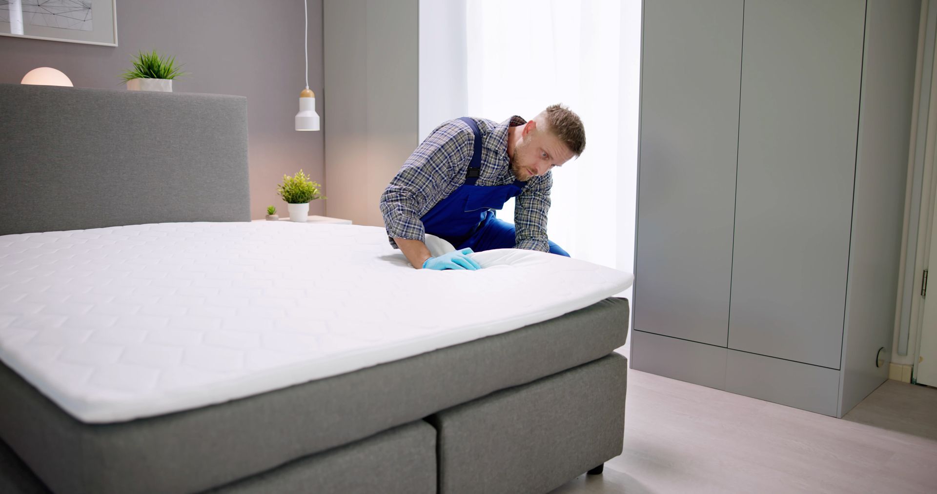 Man is Cleaning a Bed