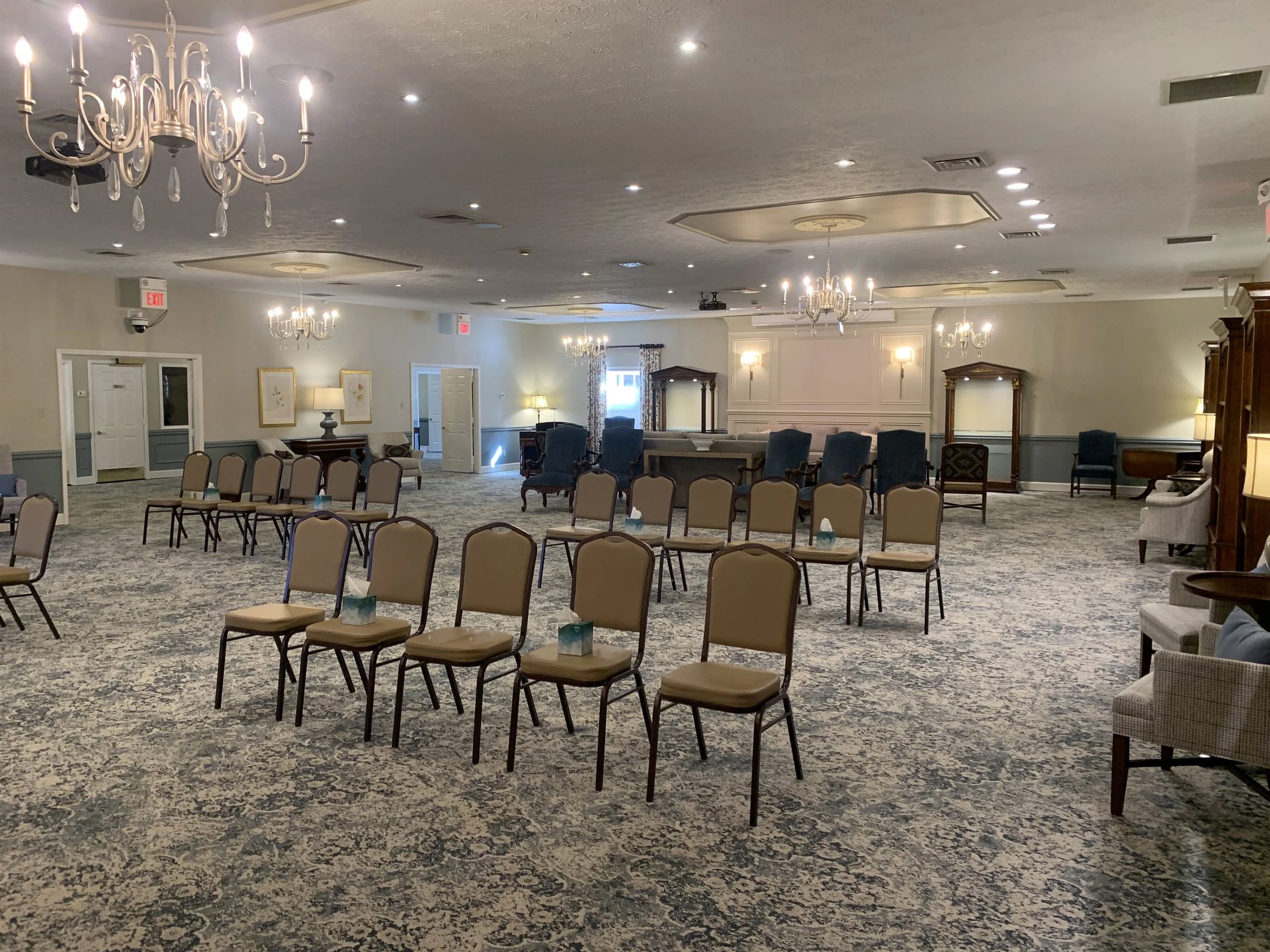 a large room filled with chairs and a chandelier .