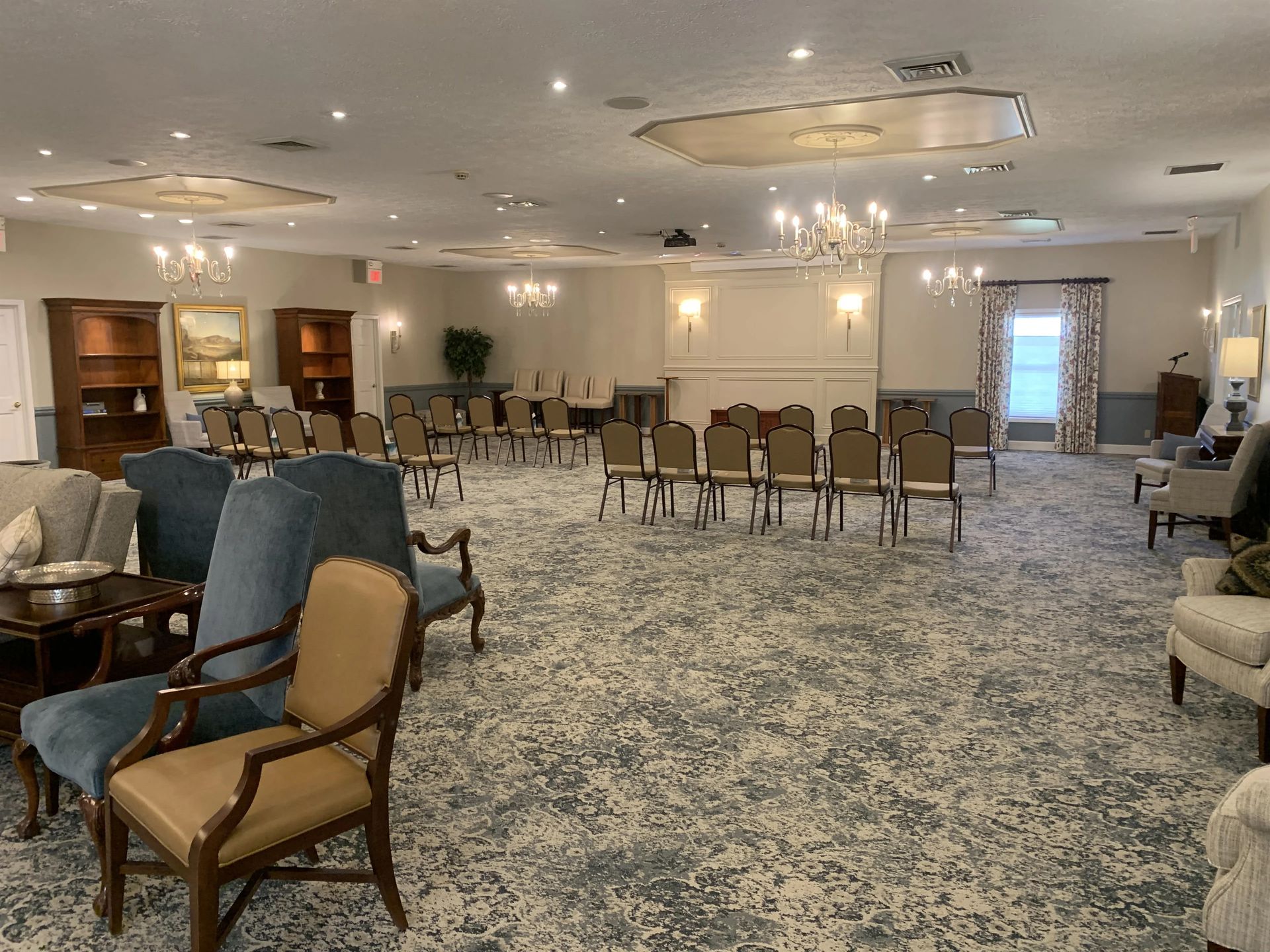 a large room with a lot of chairs and tables in it .