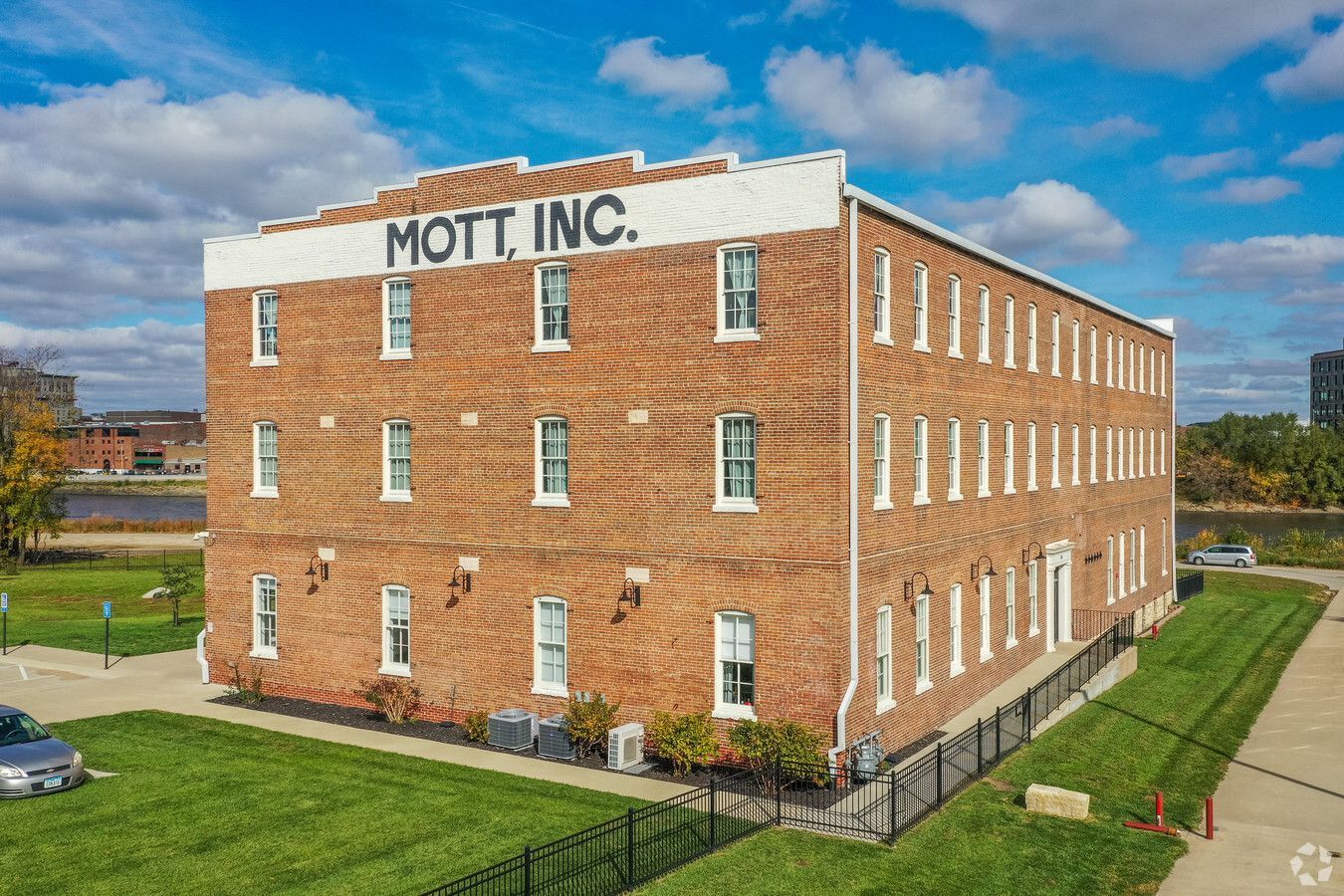 A large brick building with mott inc. written on the top