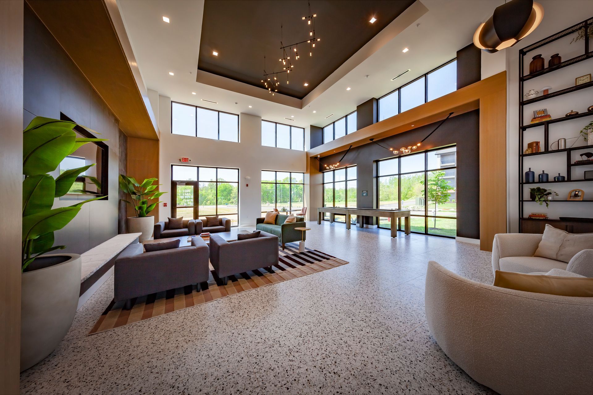 A living room with a lot of furniture and a television on the wall
