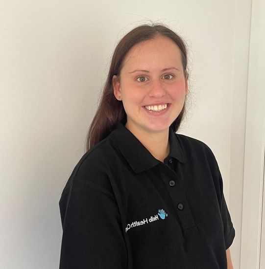 A woman wearing a black polo shirt that says public health care