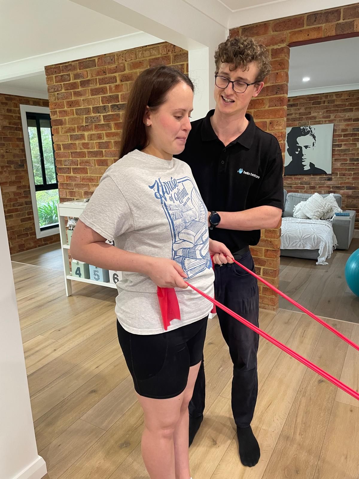 A man is helping a woman with a resistance band.