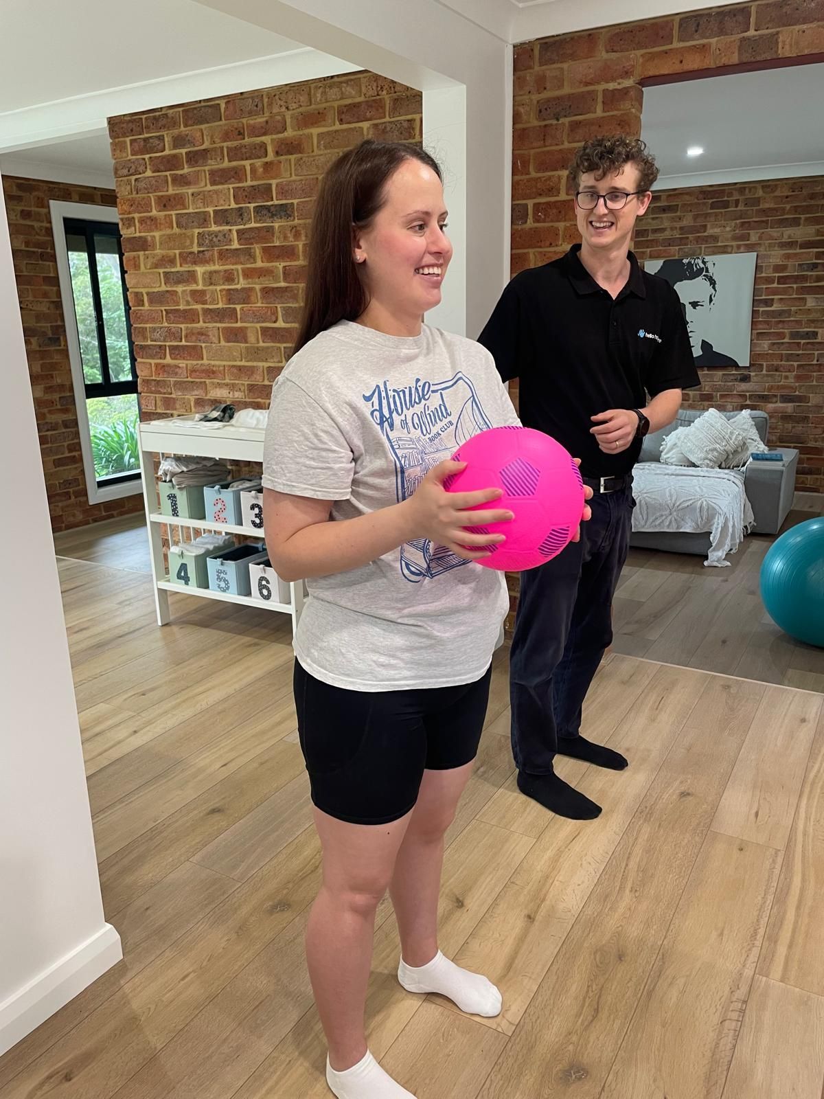 A physiotherapists is providing exercise to a NDIS client in Castle Hill