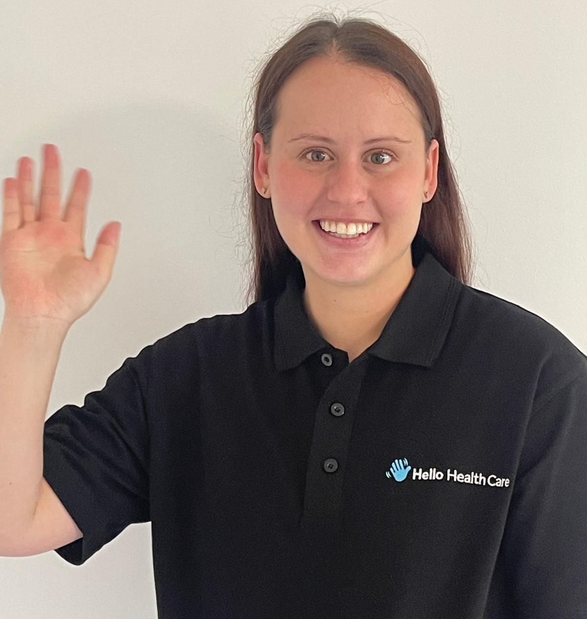 A woman wearing a black polo shirt that says public health care