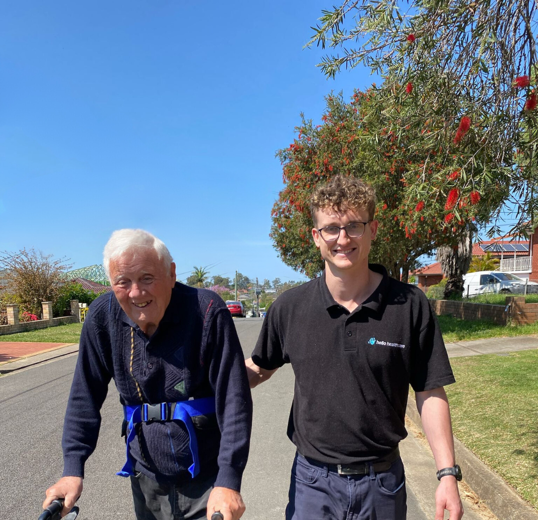 A Physiotherapist and Client are walking down a street with one wearing a shirt that says ' abercrombie & fitch ' on it