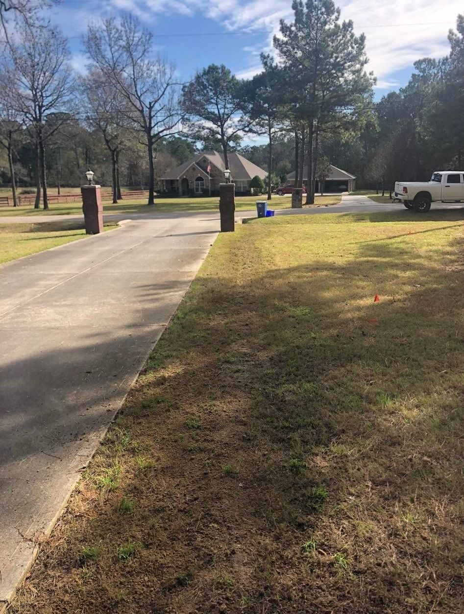 A white truck is parked in the driveway of a house.