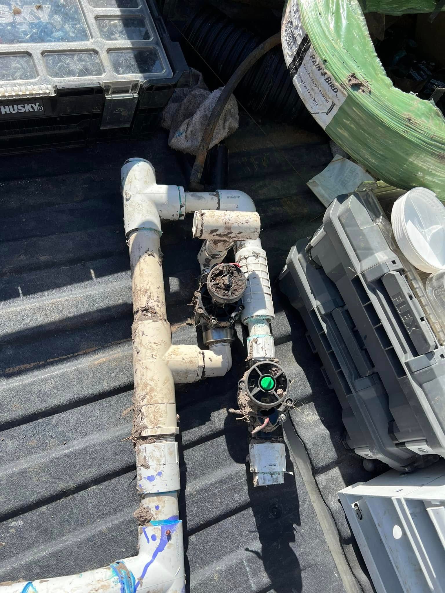 A bunch of pipes are sitting on top of a truck bed.