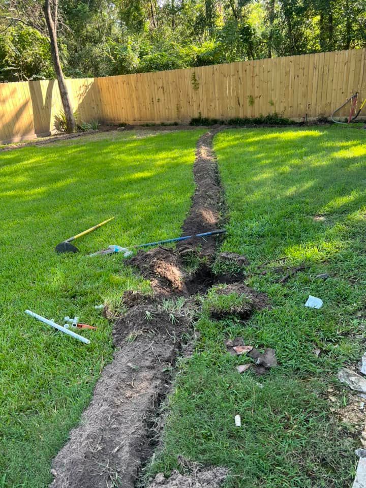 A drainage system is being installed in a backyard.