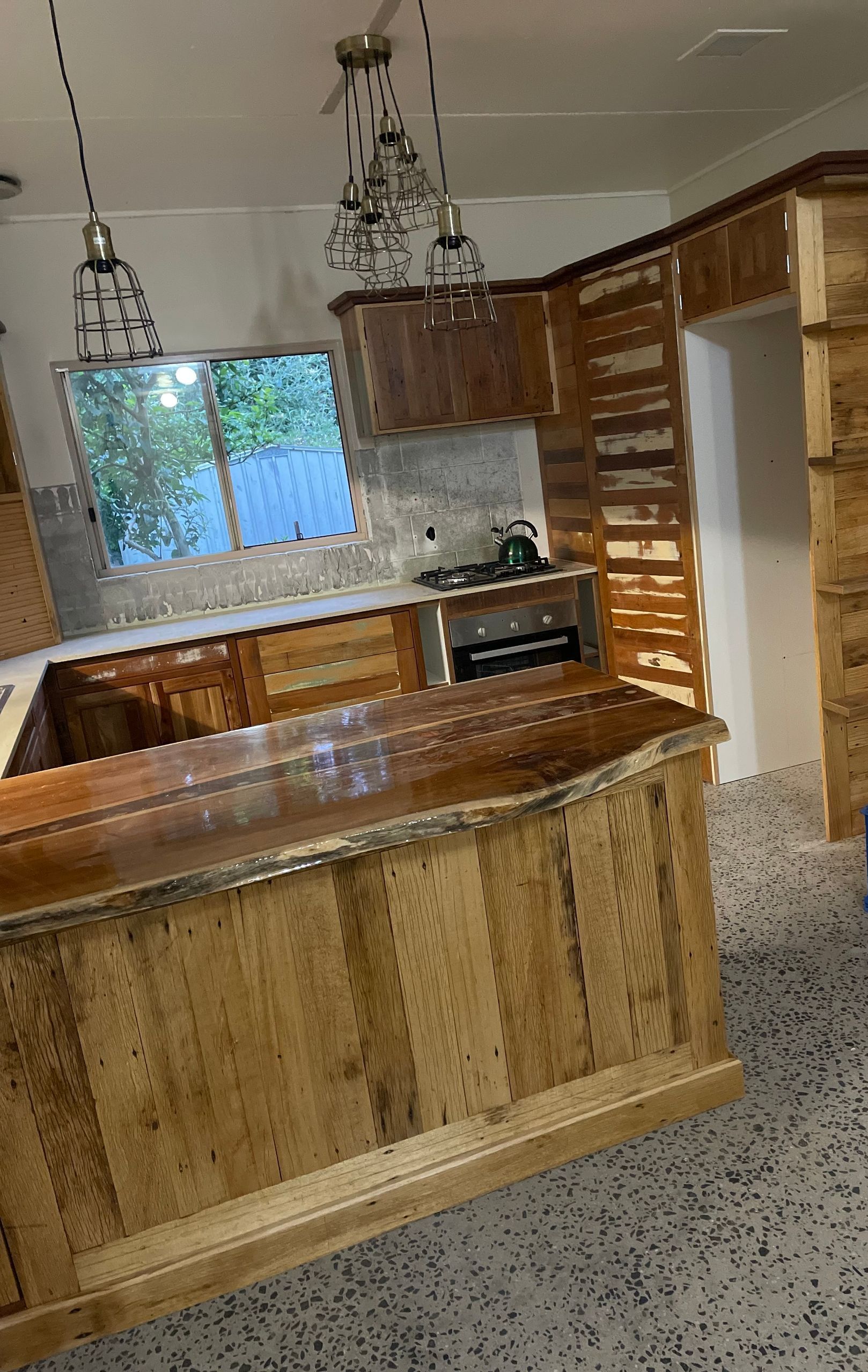 Kitchen With Wood Cabinets and Island, Stainless Steel Appliance — Tim Thomas Carpentry in South Townsville, QLD