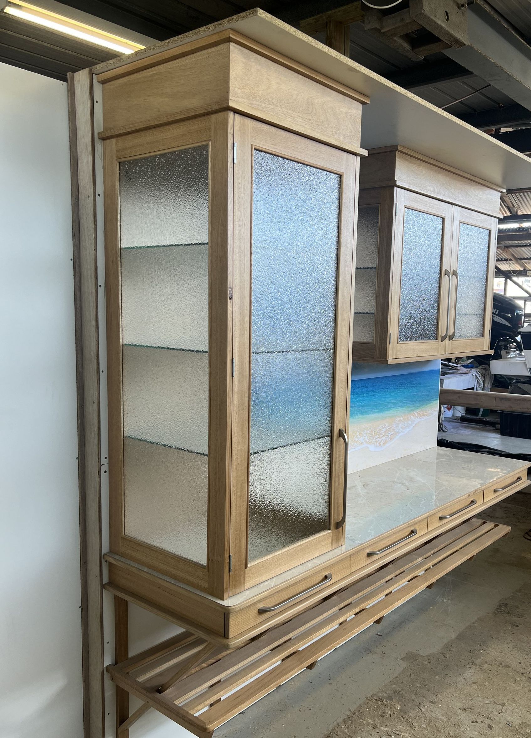 Wooden Kitchen Cabinets With Textured Glass Doors, Mounted on a Counter — Tim Thomas Carpentry in South Townsville, QLD