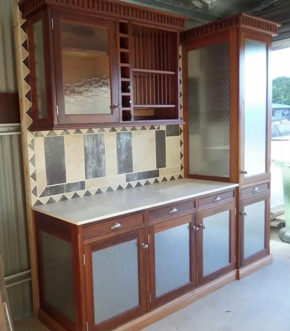 A Wooden Cabinet With a Marble Counter Top — Tim Thomas Carpentry in South Townsville, QLD