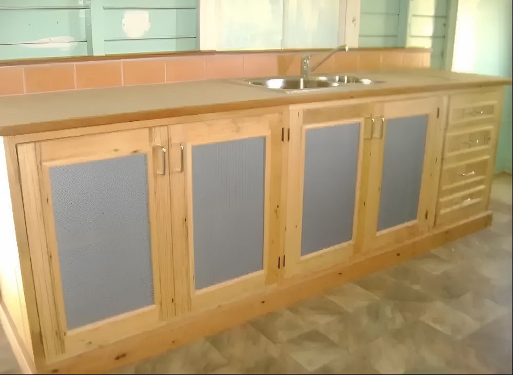 Kitchen Island With Light Wood Cabinets, Sink, and Four Glass-paneled Doors — Tim Thomas Carpentry in South Townsville, QLD