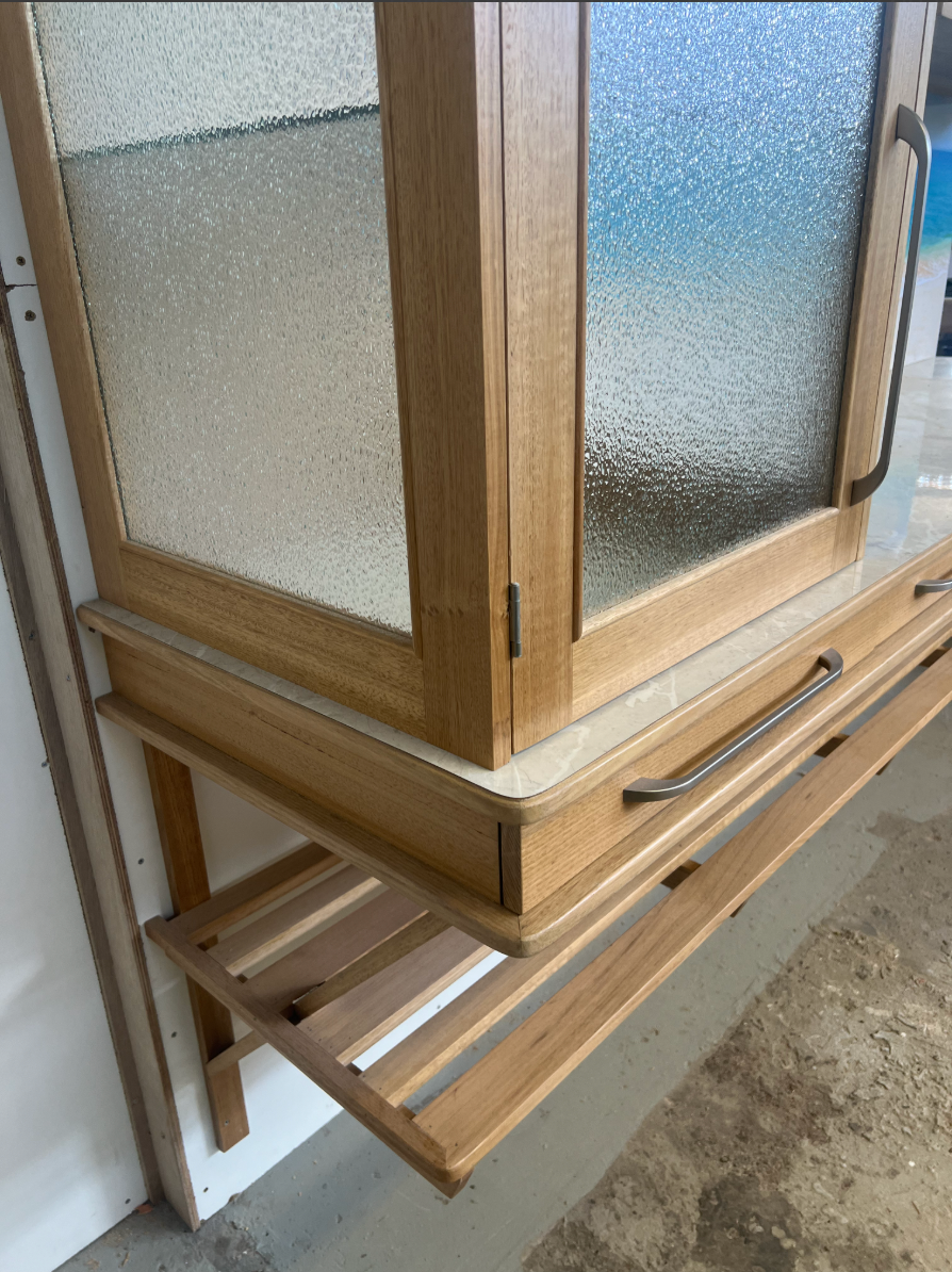 An Empty Kitchen With Wooden Cabinets and Hardwood Floors — Tim Thomas Carpentry in South Townsville, QLD
