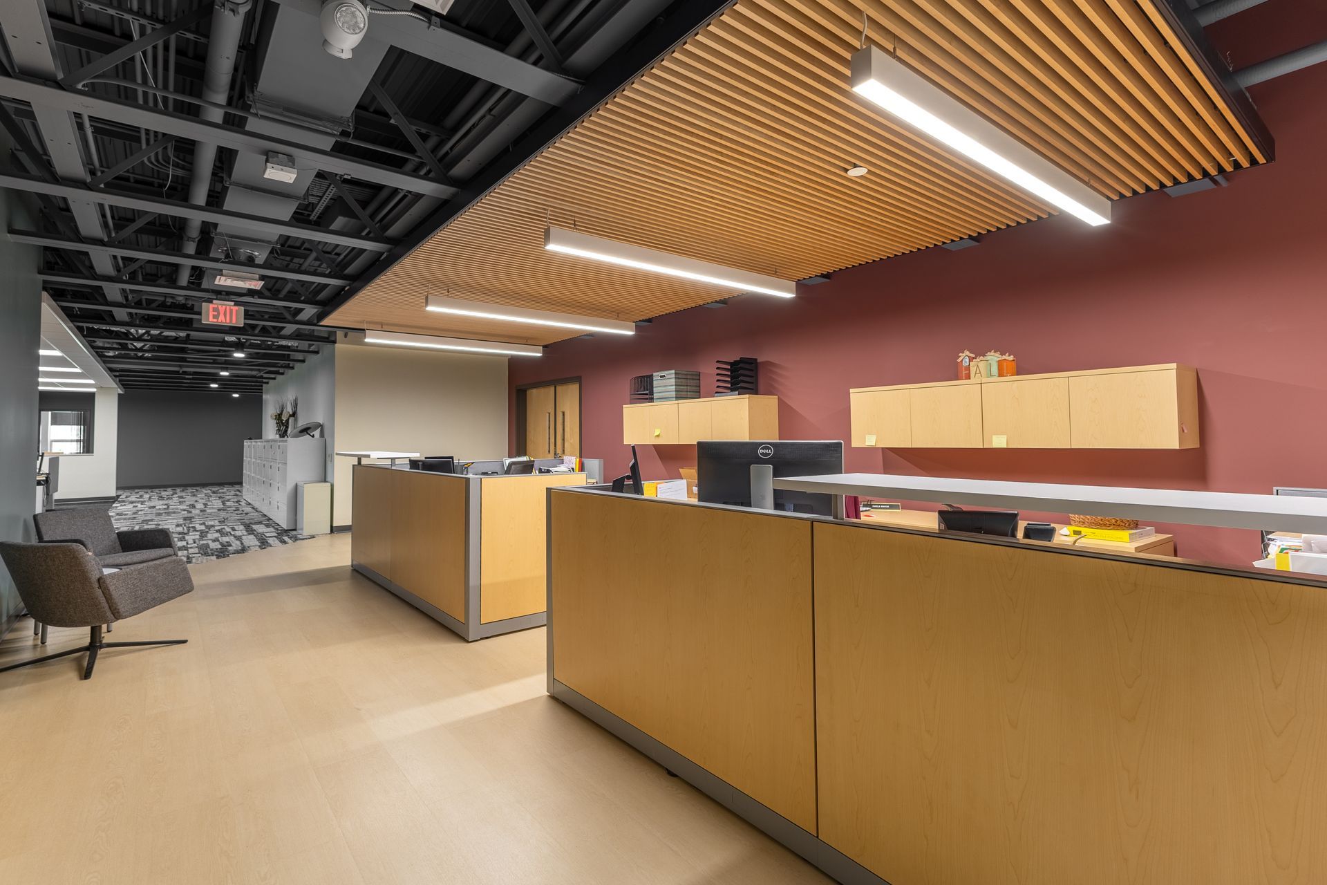State College Area School District Panorama Village building's modern office reception area with wood counters, pendant lighting, and exposed ceiling.