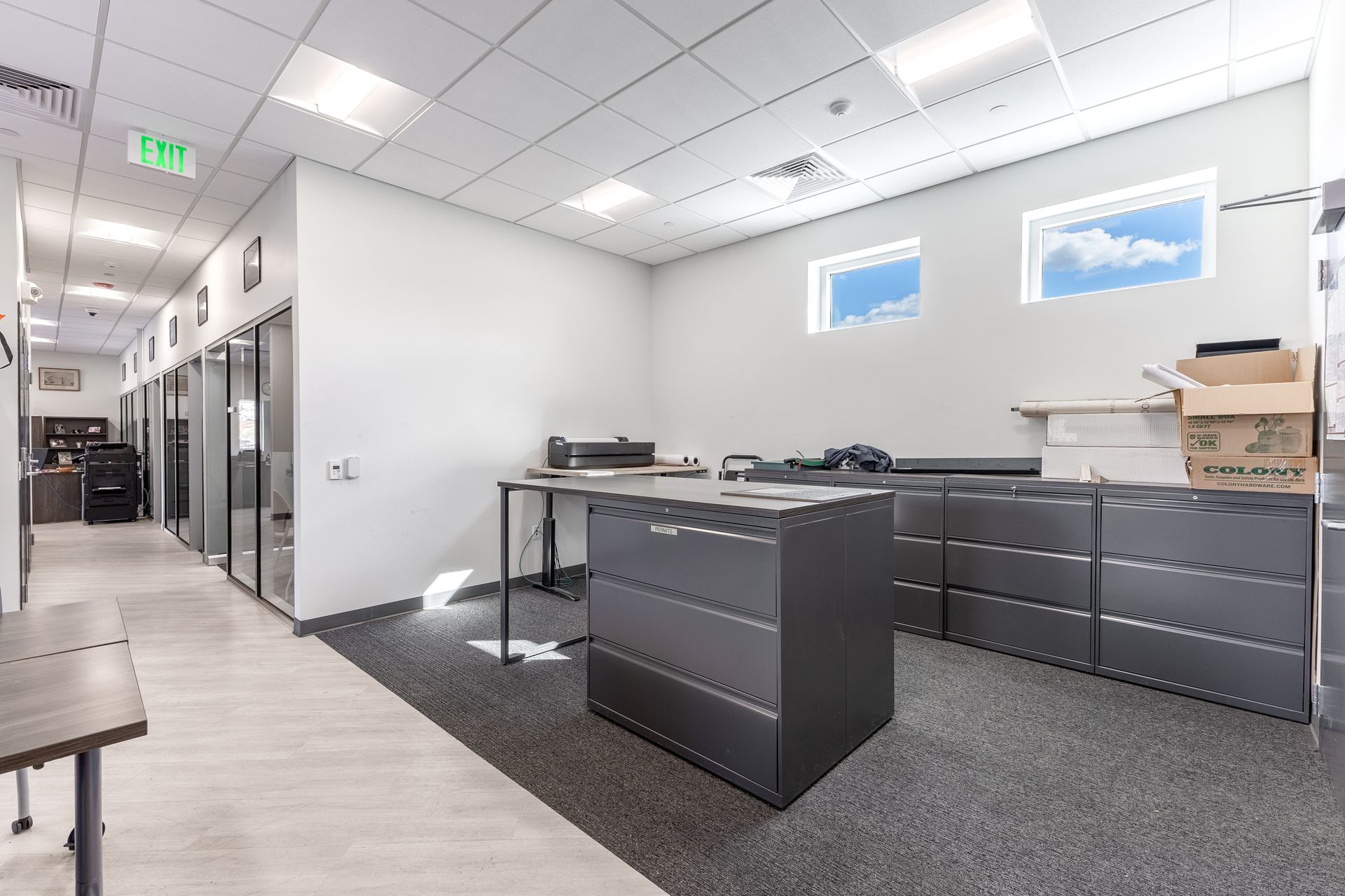 State College Area School District Physical Plant Building's office with desks, storage cabinets, hallway, and overhead lights