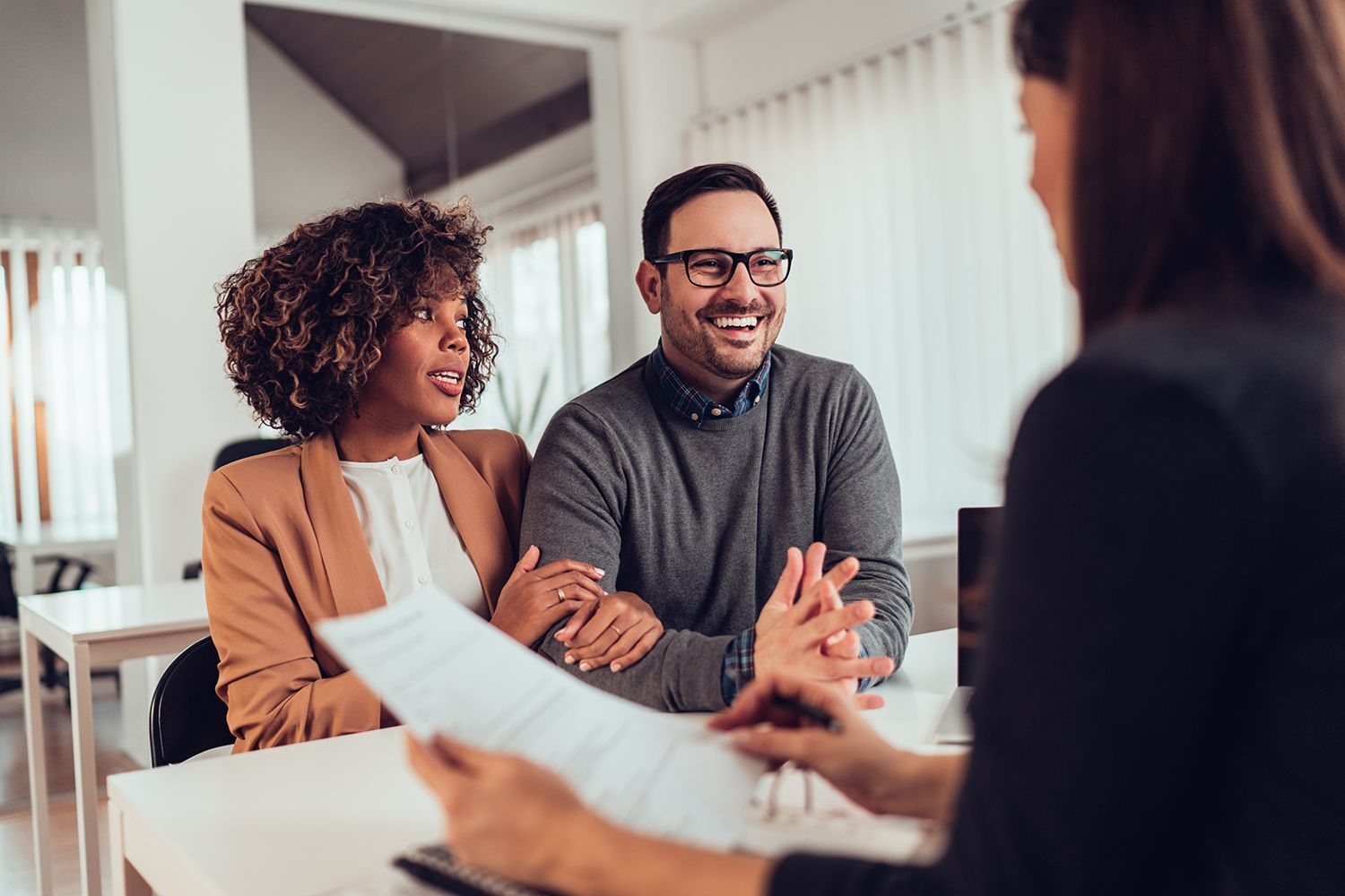 Couple meeting with a financial advisor to discuss plans.