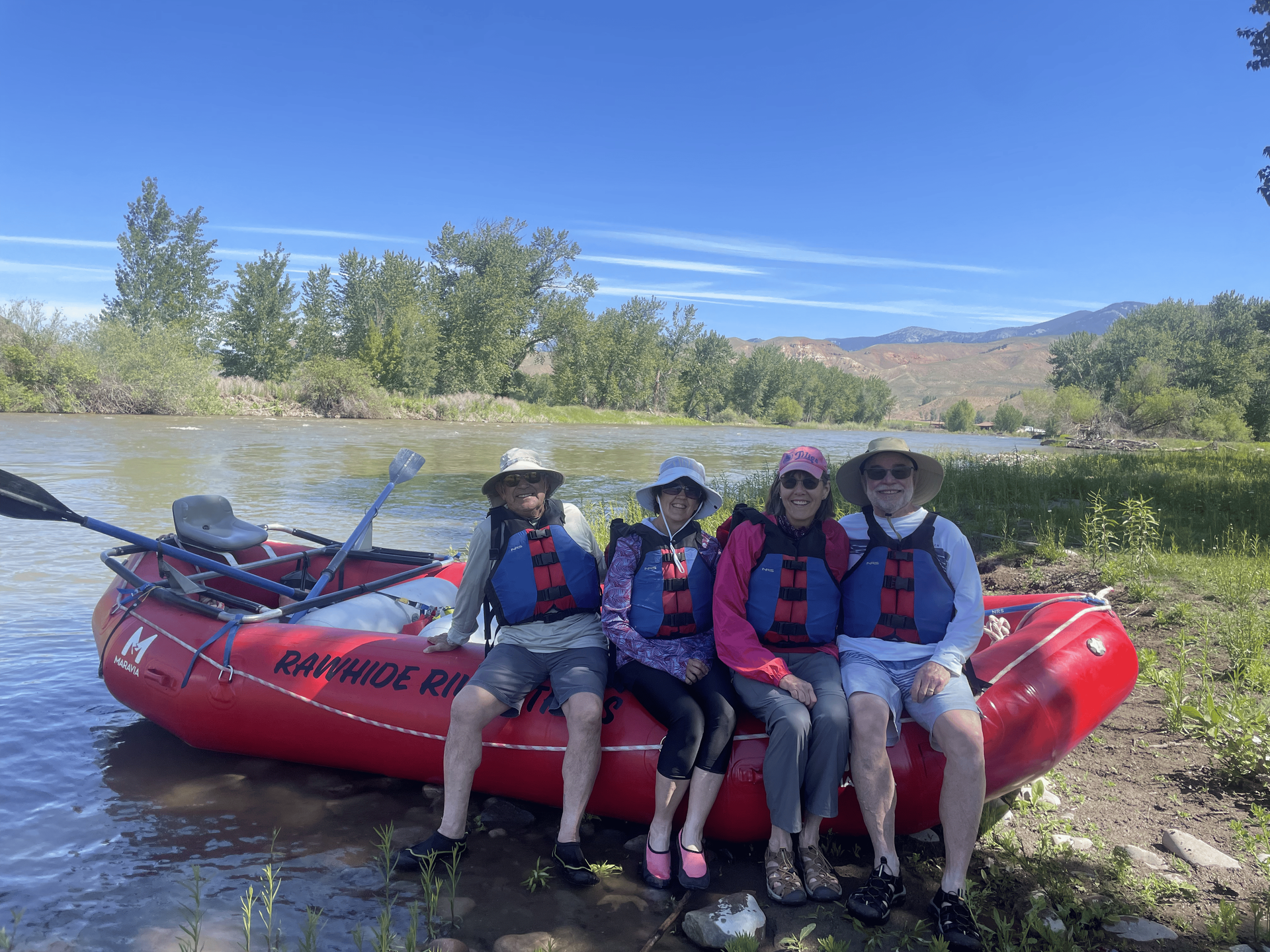 A group of rafters in high-quality gear enjoying a Salmon River rafting trip in Idaho.