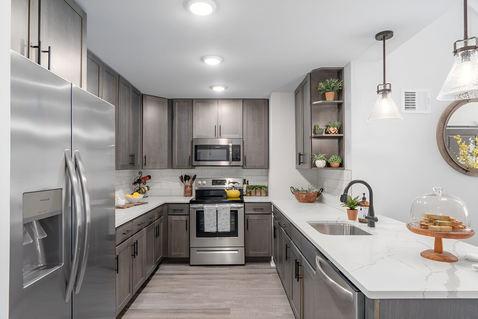 beautifully designed kitchen with sleek stainless steel appliances in an one bedroom apartment unit