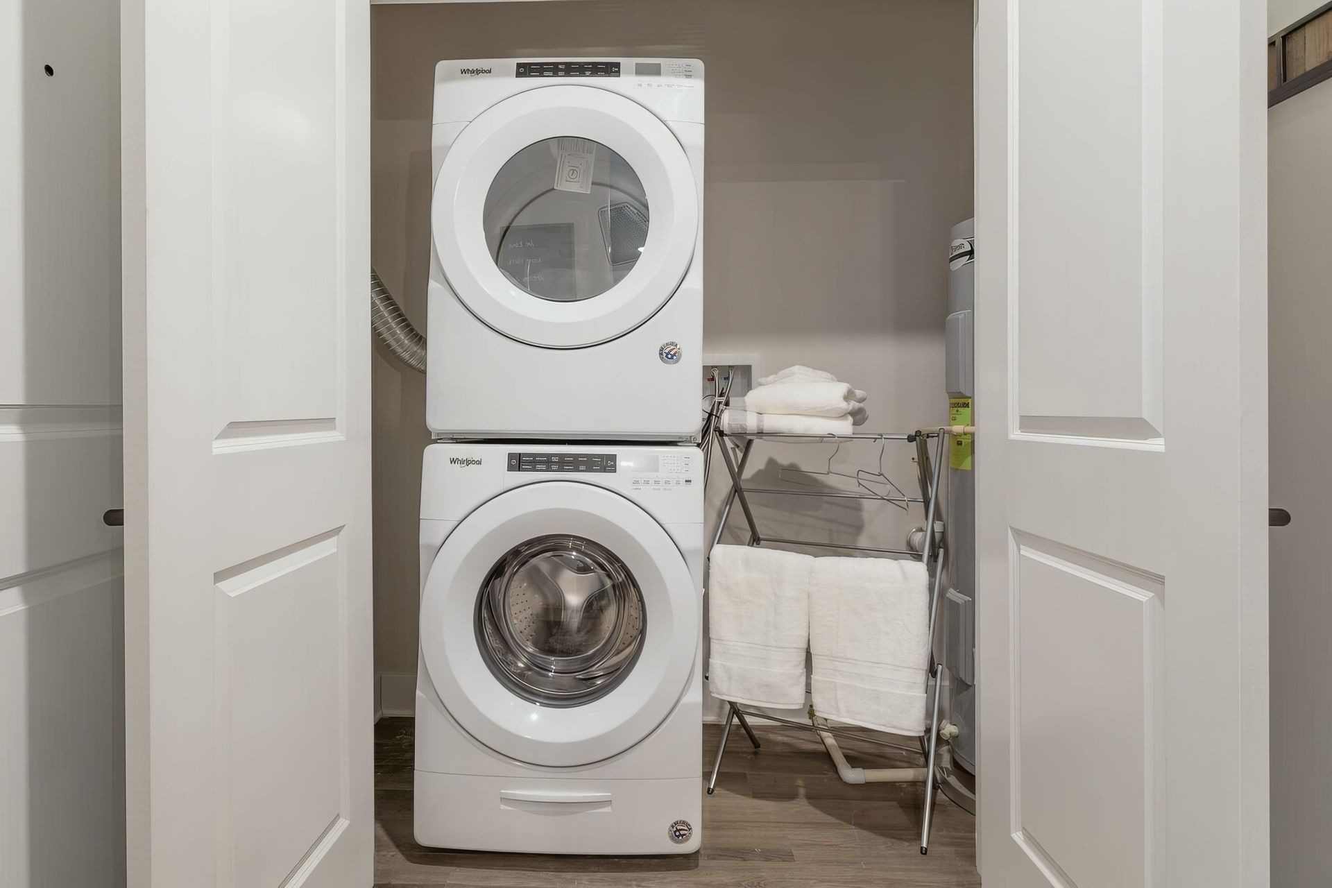 Convenient laundry room in luxury apartment for rent with washer, dryer and water heater.