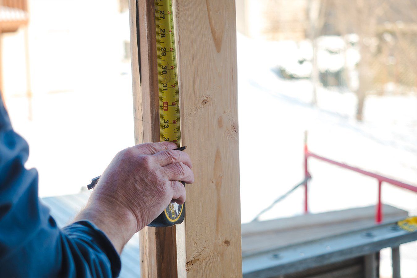 a man measuring the deck