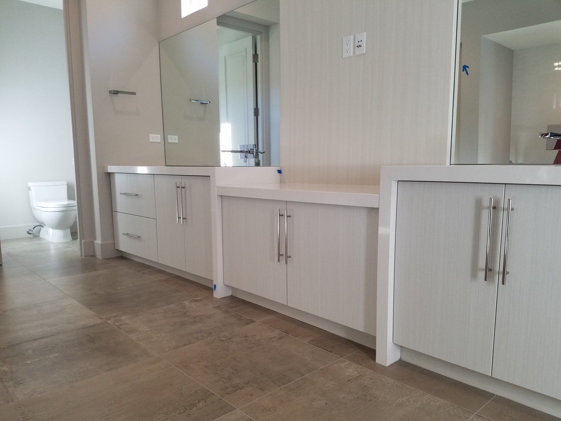 Bathroom With White Cabinet And Wide Mirror - Beaumont, CA - Absolute Cabinets Inc