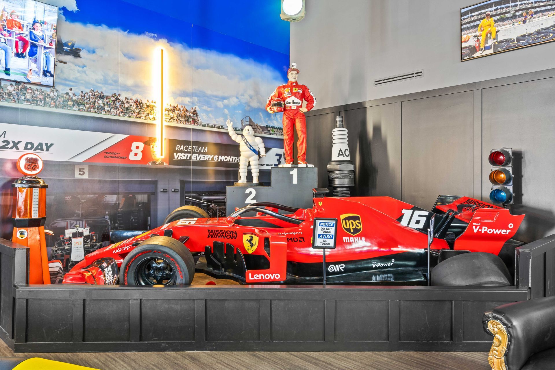 Grand Prix Dental in Katy, TX A red race car is sitting on top of a podium in a room. F1