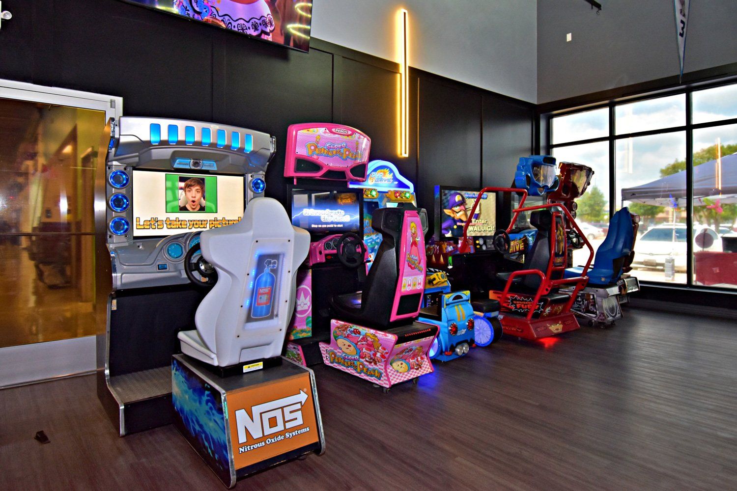 Grand Prix Dental in Katy, TX A bunch of arcade games are lined up in a room.