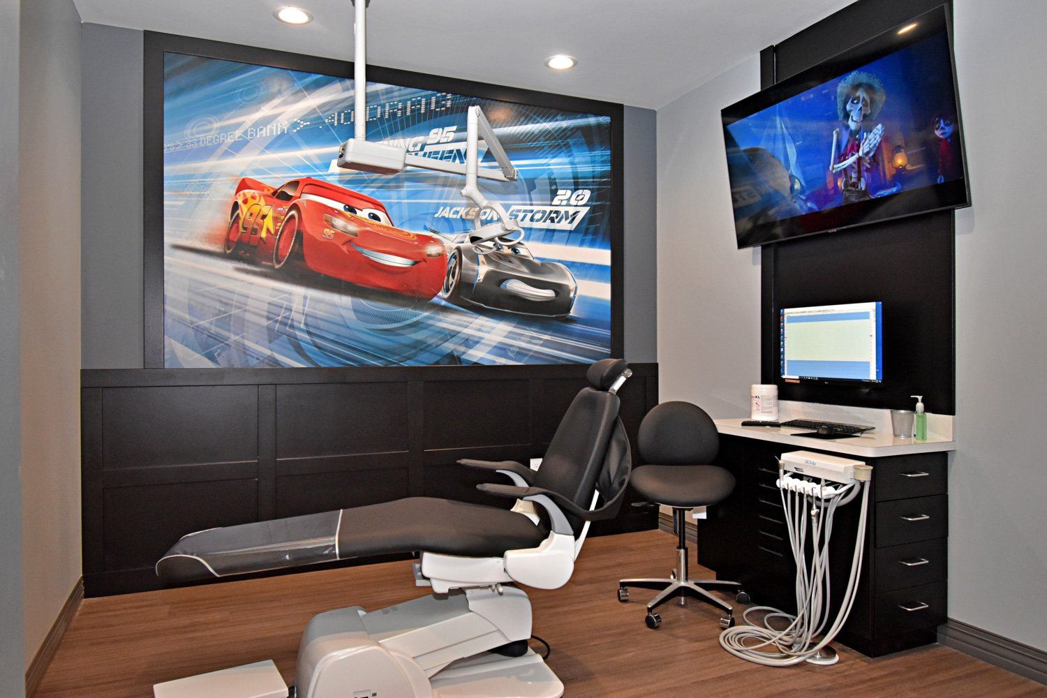 Grand Prix Dental in Katy, TX A dental office with a picture of cars on the wall.